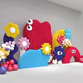 Colorful Felt Floral Art Installation With Flower Shapes Eye Elements Arch Decorations And Balloons