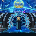 Futuristic Tech Stage Design With Blue Lighting Circular Structure Central Figure And Large Screens