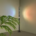 Modern Floor Lamp With Green Plant And Colorful Light Projection On Light Colored Wall