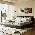 Cozy Bedroom Interior Featuring Black Leather Headboard Patterned Mattress Wall Art And Flowers