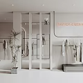 Fashion Clothing Store Interior with Hanging Clothes Display Area and Decorative Plant