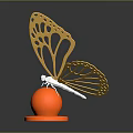 Golden Butterfly Metal Sculpture With Orange Round Base And Intricate Wing Design
