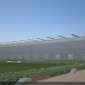 Modern Industrial Factory Building With Glass Curtain Walls Metal Roof And Green Surroundings