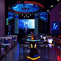 Futuristic KTV Interior With Neon Lighting Comfortable Seating And Large Screens