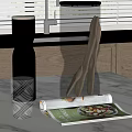 Elegant Decorative Ornament Set Featuring Metallic Vase Transparent Glass Cup And Magazine On Kitchen Countertop