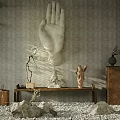 Serene Interior Landscape Featuring Large White Palm Sculpture Gray Wall Wooden Bench Pebble Floor