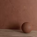 Brown Sphere Component On Wooden Tabletop Against Textured Brown Wall