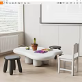 White Children's Table With Unique Shape Black Stools White Chair Colorful Drawing Potted Plant