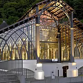 Modern Museum Architecture With Glass Facade Arched Roof And Green Hills