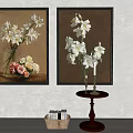 Two Framed Floral Paintings With White Flowers Vases Candles Small Table Woven Basket And Bottles
