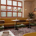 Café Interior Design With Arched Doorways Chandeliers Patterned Tiles Booth Seating And Colorful Chairs