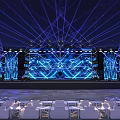 Large Stage With Blue Lighting Big LED Screen And White Seats For Live Event Setup
