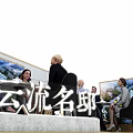 Modern Exhibition Booth Tables and Chairs with People Interacting and Display Backdrops