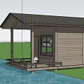 Wooden House With Solar Panel Roof And Wooden Deck By Waterfront