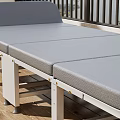 Outdoor Patio Foldable Gray Lounge Chair With Wooden Floor Scenic View And Potted Plants