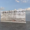 Weathered Building Exterior Wall With Peeling Surface And Exposed Red Bricks Against Sky