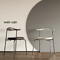 Wabi Sabi Style Black And White Dining Chairs With Minimalist Design And Circular Backdrop