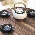 Modern Tea Set With White Teapot Black Teacups And Saucers On Wooden Table