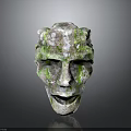 Mystical Stone Mask Depicting Ancient Character With Moss Covered Creature Features And Weathered Texture