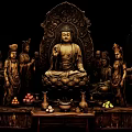 Traditional Buddha Sculpture Display With Central Figure Surrounding Statues Offerings And Vases
