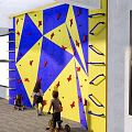Fun Indoor Kids Climbing Wall with Blue and Yellow Surface and Red Star Shaped Holds