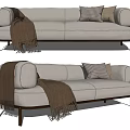 Light Colored Two Seater Sofa With Checkered Pillows Brown Blanket And Dark Legs