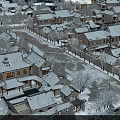 Scenic View of Traditional Village With Snow Covered Roofs Lit At Night And Snowy Trees