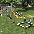 Kindergarten Outdoor Playground With Climbing Frame Slide Grass Lawn And Trees