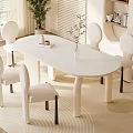 Modern Oval Dining Table Set With Four Cream Colored Chairs And Beige Rug
