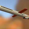 Tomahawk Missile With Orange Nose White Body And Orange Tail Fins Flying Over Natural Landscape