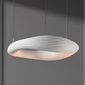 Modern White Wavy Striped Pendant Light Hanging From Gold Rods In Minimalist Gray Wall Background