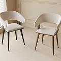 Modern Dining Chairs with Light Upholstered Seats and Contrasting Wooden Legs