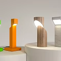 Colorful Modern Table Lamps With Green Orange Wood And Concrete Bases On Display Stands