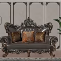 Ornate Carved Leather Double Sofa With Orange Patterned Pillows On Wooden Floor And Patterned Rug