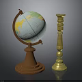 Vintage Globe With Brown Base And World Map Next To Golden Ornate Candle Holder