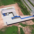 Aerial View Of Construction Site With Building Structure Construction Equipment Road And Green Trees