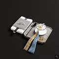 Traditional Ceramic Teacup with Spoon Chopsticks and Tassel on Gray Tray with Geometric Mat