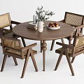 Wooden Round Dining Table Set With Rattan Chairs Decorative Vase Books And Fruit Bowl