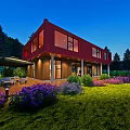 Red Single Family House With Large Windows Lush Green Lawn Purple Flowers Outdoor Seating And Evening Sky