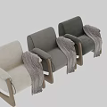 Cream Colored Lounge Chair With Wooden Curved Armrests Legs And Herringbone Pattern Blanket