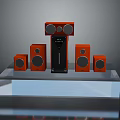 Computer Speaker System Featuring Multiple Orange Speakers And Black Central Unit On Display Platform