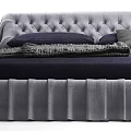 Modern Tufted Bed With Pleated Skirt And Navy Bedding