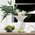 White Vase with White Flowers Green Leaves on Wooden Table with Pears and Artwork