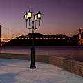 Illuminated Golden Gate Bridge at Twilight with Calm Water Street Lamp and Mountain Views