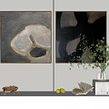 Two Abstract Paintings With Dark Background And Light Shapes On White Wall With Green Plant Vase And Marble Surface