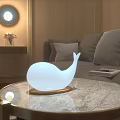 Whale Shaped White Decorative Lamp on Marble Coffee Table in Modern Living Room with Sofa