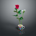 Red Rose and Small White Flower Arranged in Colorful Decorative Cup