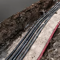 Underground Black and Red Pipes Laid in Soil and Concrete Construction Area