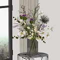 Transparent Glass Vase With White Purple Flowers And Green Leaves On Window Tabletop