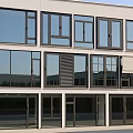 Modern Commercial Building Exterior With Sleek Casement Windows And Glass Panels